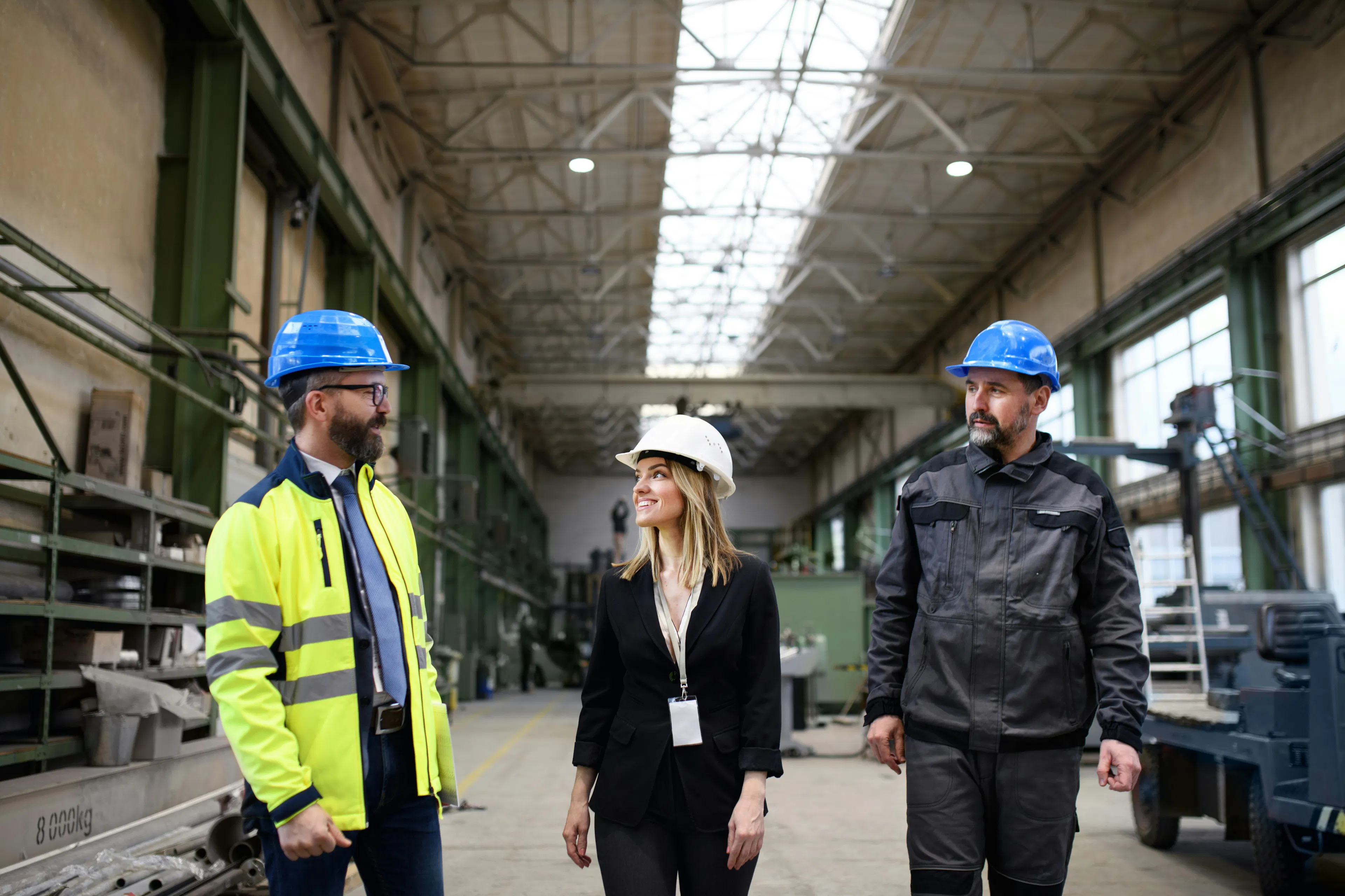 Three industrial team members in conversation at facility