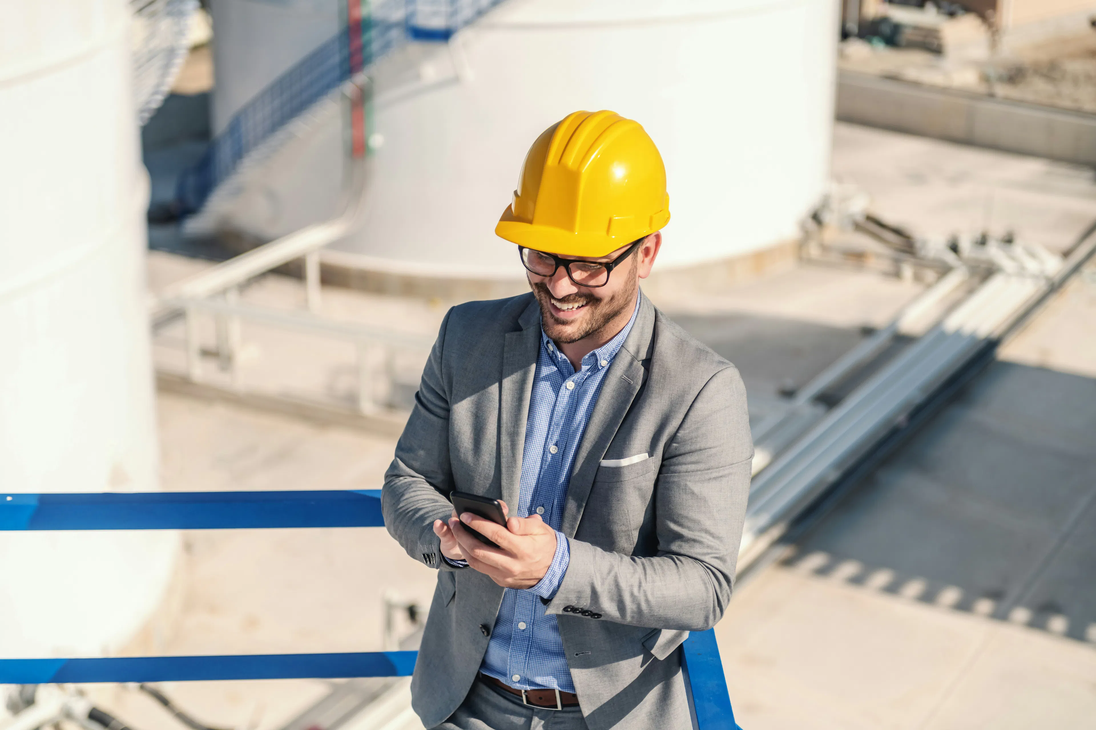 operations manager in hard hat a reading message