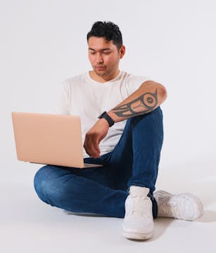 Photo of an Indigenous teen boy working on his laptop, photo by Supernaturals Modelling
