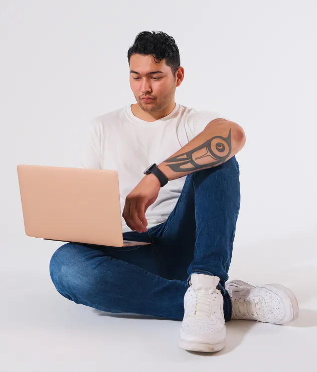 Photo of an Indigenous teen boy working on his laptop, photo by Supernaturals Modelling