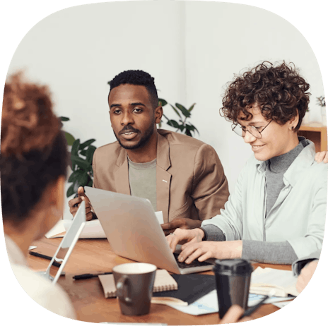 Man smiling, woman typing