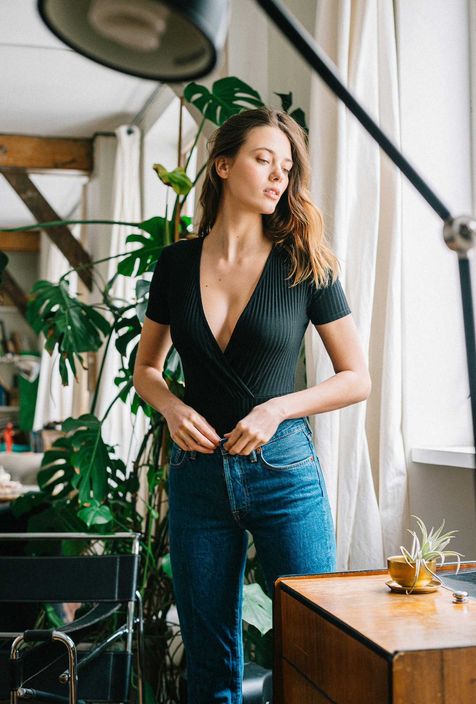 Gaia bodysuit in black worn with a pair of jeans