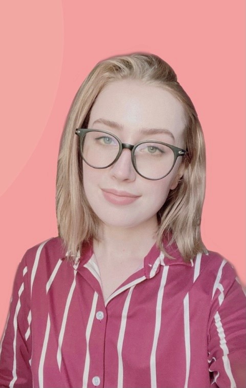 A headshot of a young Caucasian woman with shoulder-length, straight, blonde hair and dark glasses smiling at the camera.
