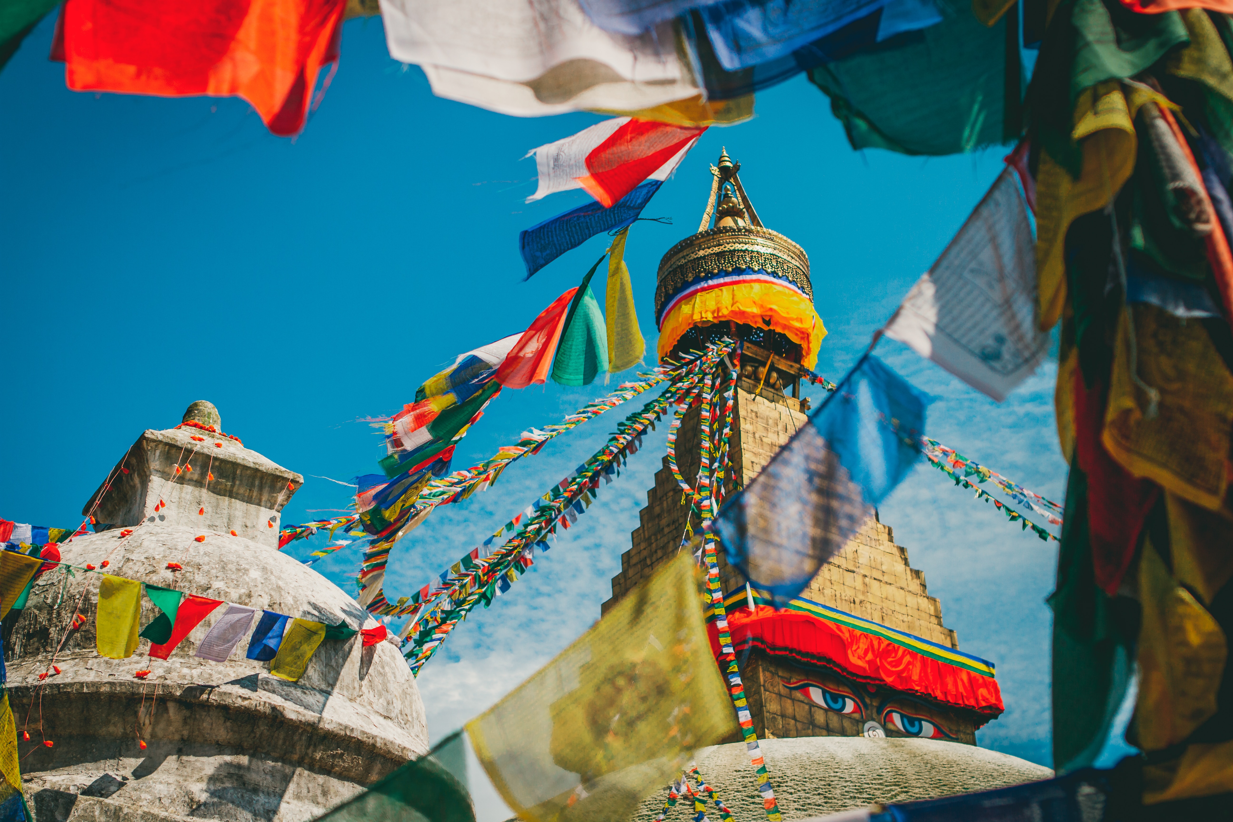 Colorful prayer flags drape over the top of temples in Nepal.