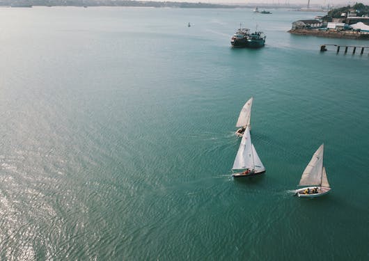 Along the Kenyan Coast, you can see a few small sailboats not far from land.