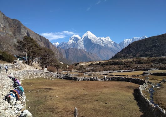A view across some brown plains with white mountain peaks in the background along the Amadablam Base Camp in Nepal.