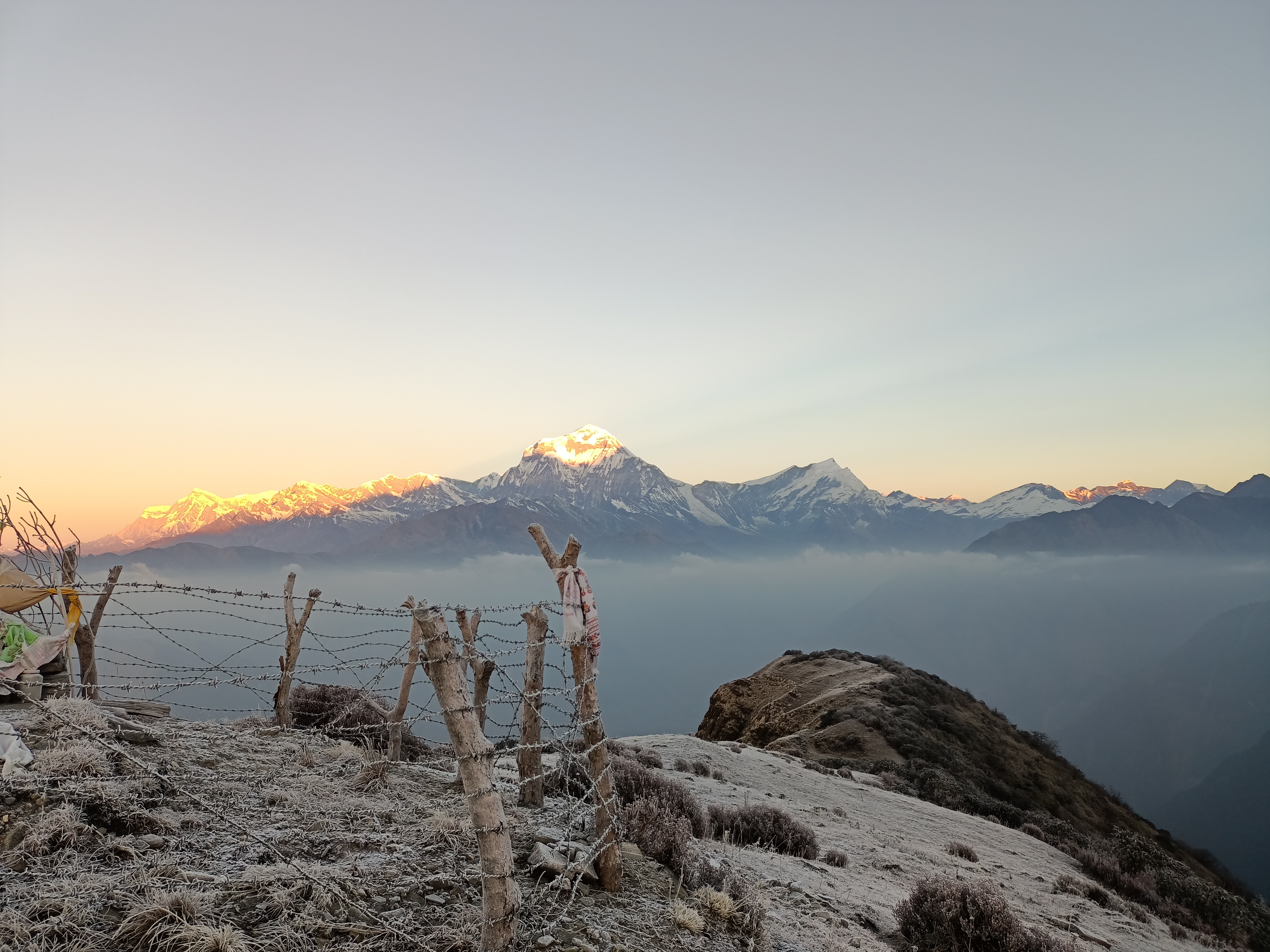 Sunrise creeps over mountain peaks as seen from the Khopra Ridge Trek in Nepal.