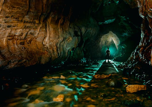 Inside the dark Venado Caves in Costa Rica in the Arenal Volcano area, with stalactites and stalagmites in view.