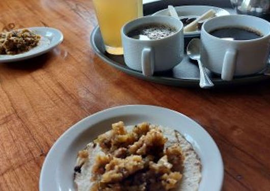 A Costa Rican snack and coffees are shown on the Trapiche Tour where visitors learn about traditional production of various goods.