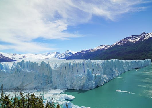 The Perito Moreno glacier in southern Patagonia of Argentina is shown, with its towering ice walls reaching a teal lagoon.