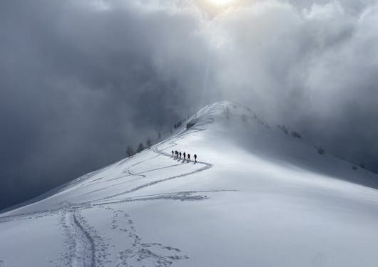 Snowshoeing up a ridge in the Alps