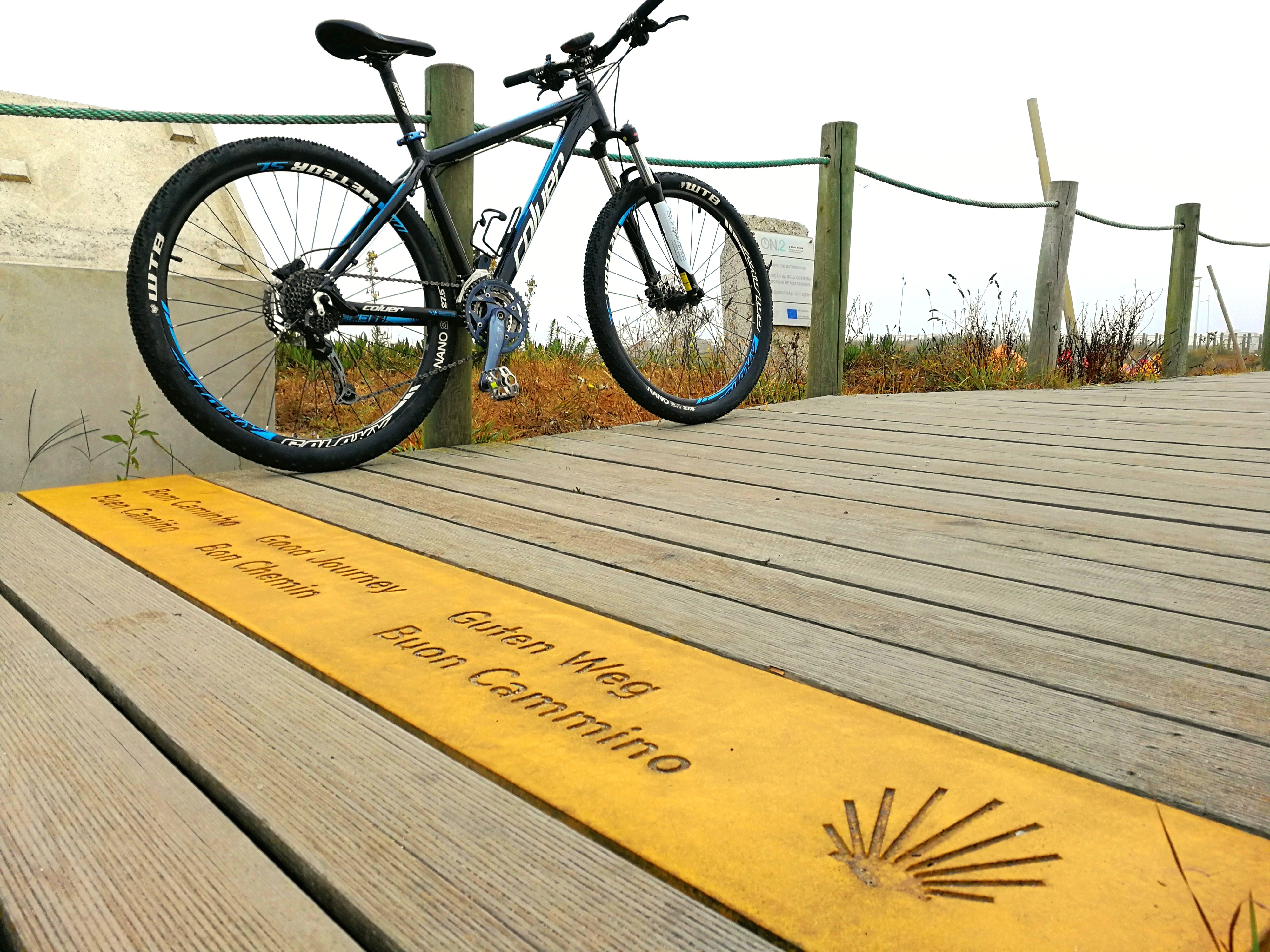 A bike rests on a wooden boardwalk along the Camino de Santiago in Portugal.