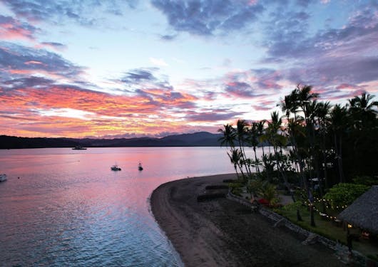 A cotton candy sunset in light pink and blue hues is shown from the secludd Isla Chiquita in Costa Rica,