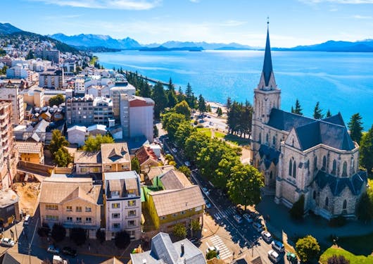The City of Bariloche in Argentina is shown from above, with the ocean off to the right and the Bariloche Cathedral in the bottom right of the frame.
