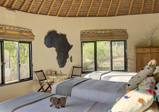 A family room at Ololo is shown with three twin beds in a row.