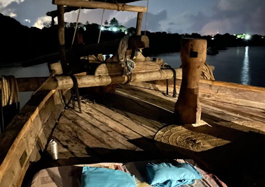 A traditional dhow boat is shown in Kenya.