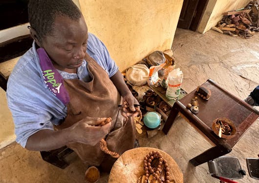 An artisan workshop shows an artisan at his craft in Kenya.