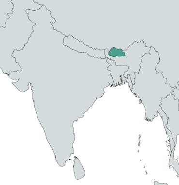 The country of Bhutan is highlighted in teal on a world map of Asia.