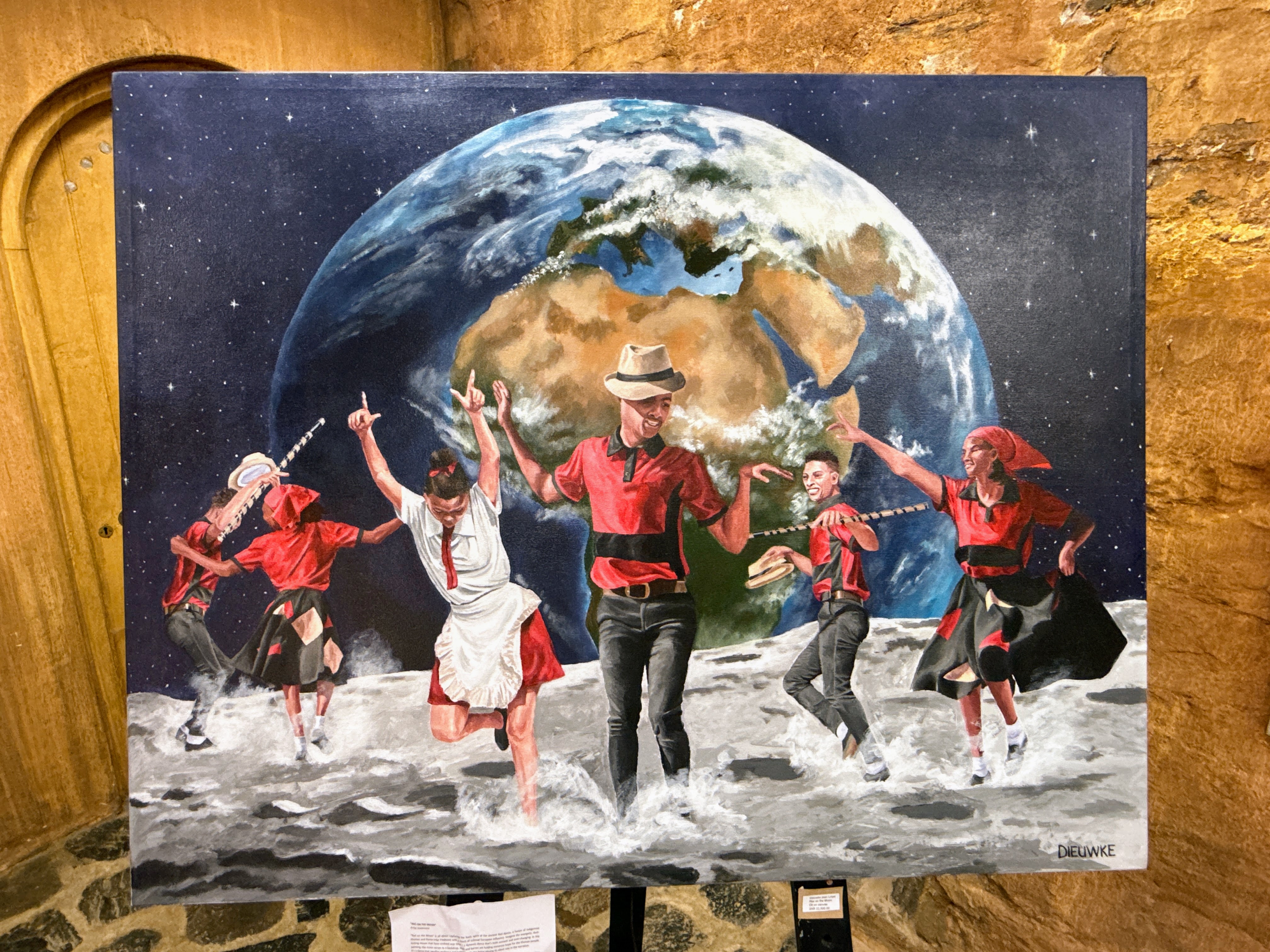 A painting at an indigenous art museum in South Africa depicts people dancing on the moon.