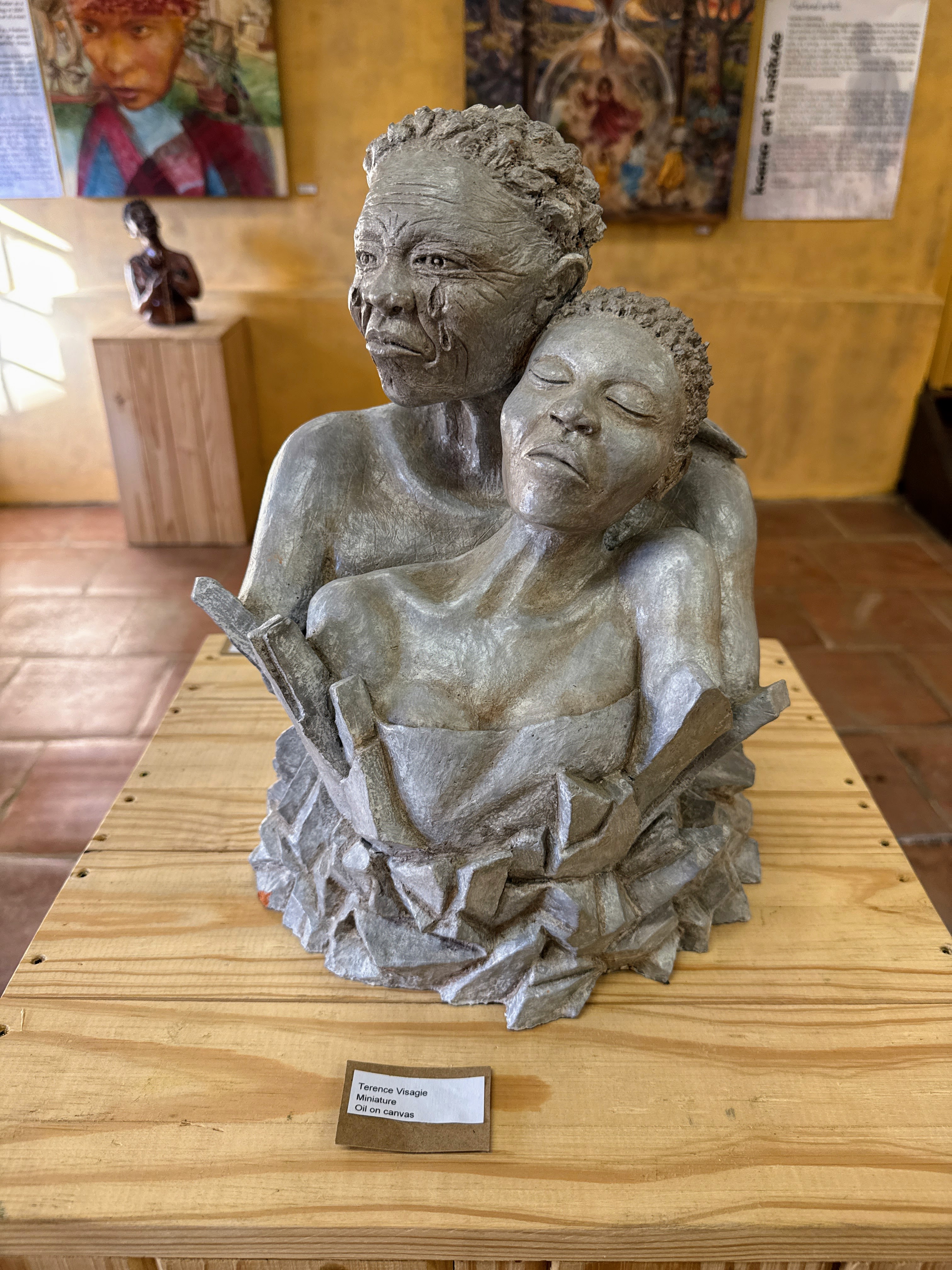 A sculpture at an indigenous art museum in South Africa depicts a bust of a mother holding her daughter.