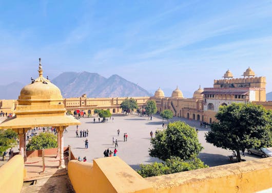 The Amber Fort in Jaipur, India, is shown with its yellow hues against a blue sky.