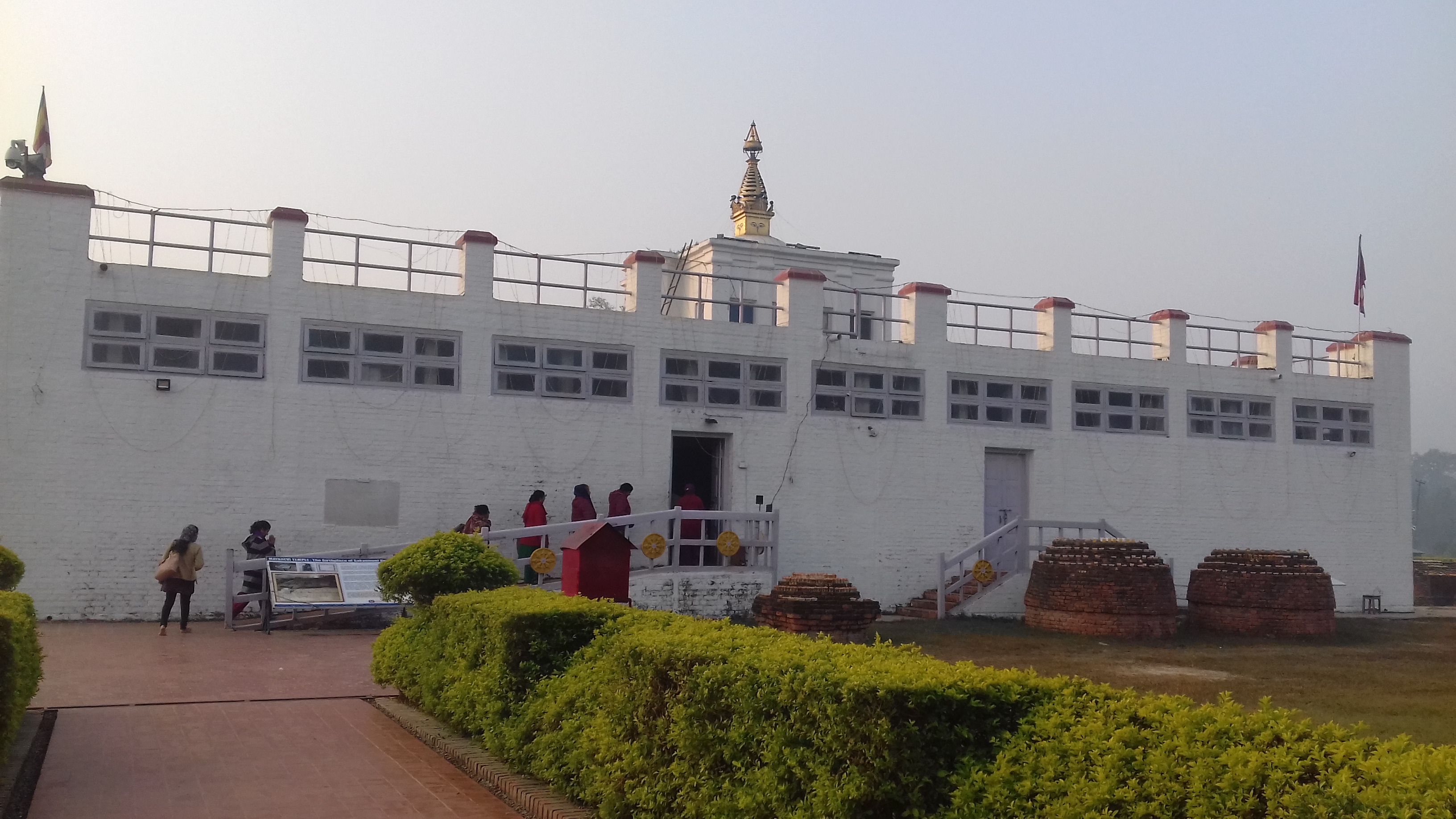 People are seen entering the white fort in Lumbini, Nepal.