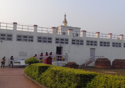 People are seen entering the white fort in Lumbini, Nepal.