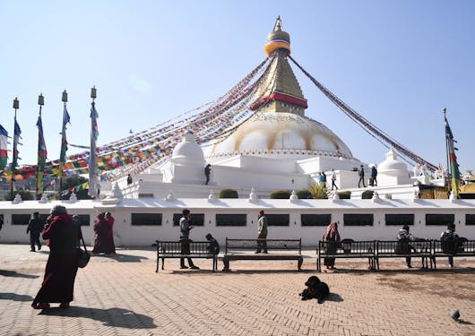 Prayer flags drape from the top of the Boudhanath Temple in Nepal.