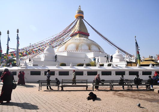 Prayer flags drape from the top of the Boudhanath Temple in Nepal.