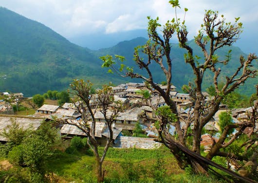 Ghandruk Village is shown from a distance on a clear day along the Annapurna Panorama Trek.