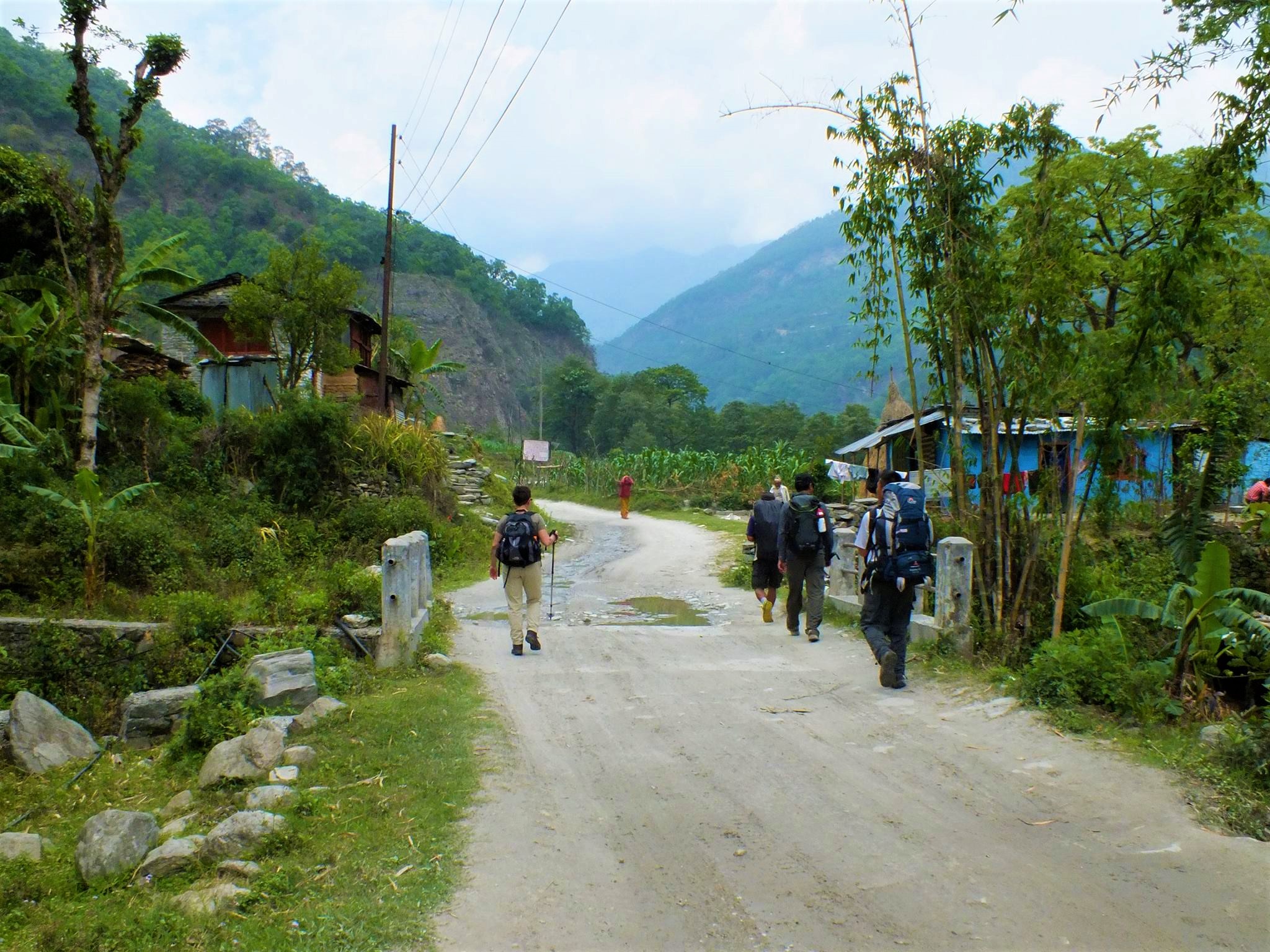 Travelers are shown walking along the path to Birethathi in Nepal on the Annapurna Panorama Trek.