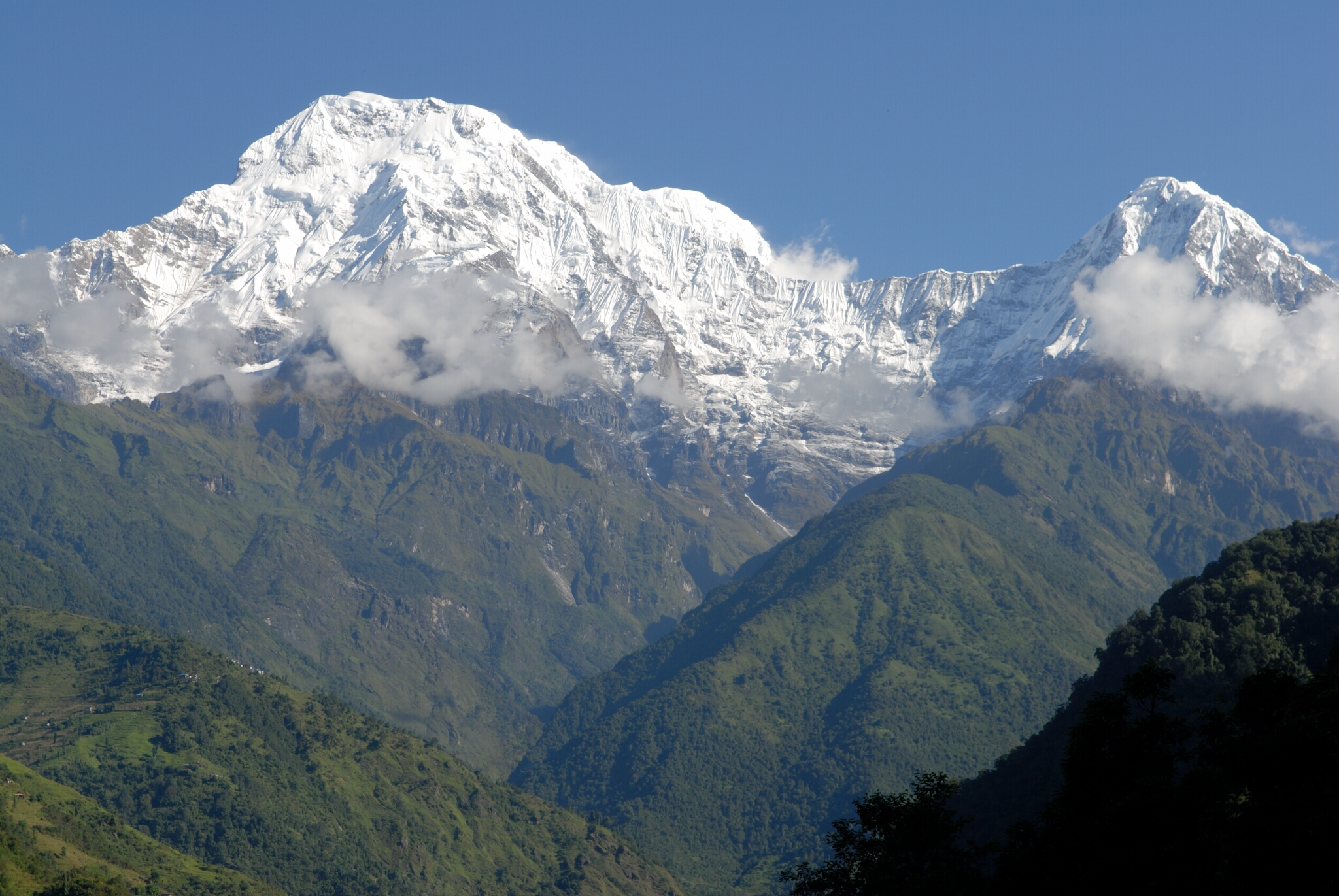 A beautiful view of snow-capped mountain peaks is shown from Landruk in Nepal.