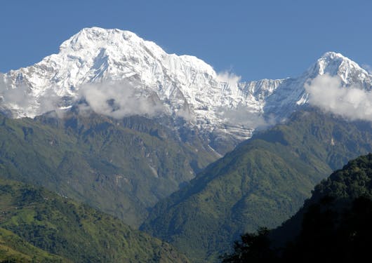 A beautiful view of snow-capped mountain peaks is shown from Landruk in Nepal.