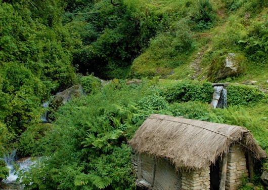 A small house near a river is shown from above on the way to Majgaun in Nepal.