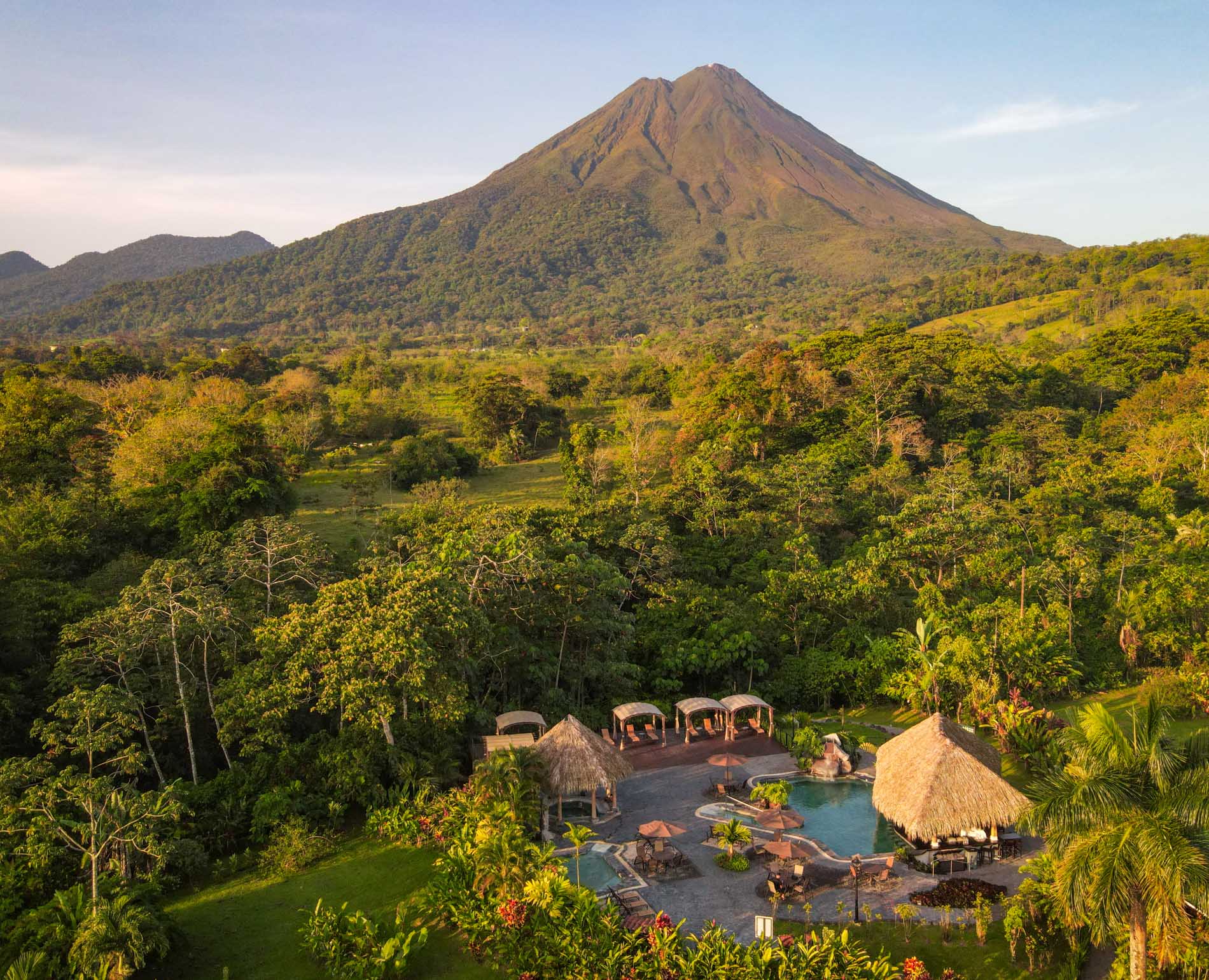 Arenal Volcano in Costa Rica is shown in the distance beyond the Manoa Hot Springs.