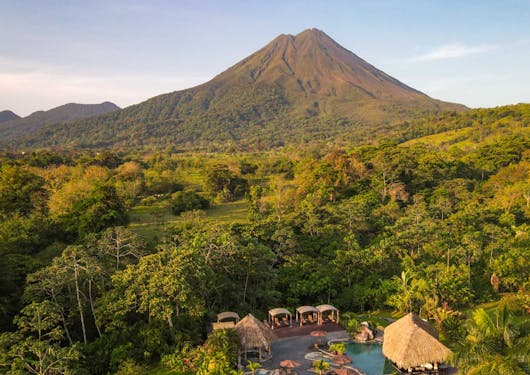 Arenal Volcano in Costa Rica is shown in the distance beyond the Manoa Hot Springs.