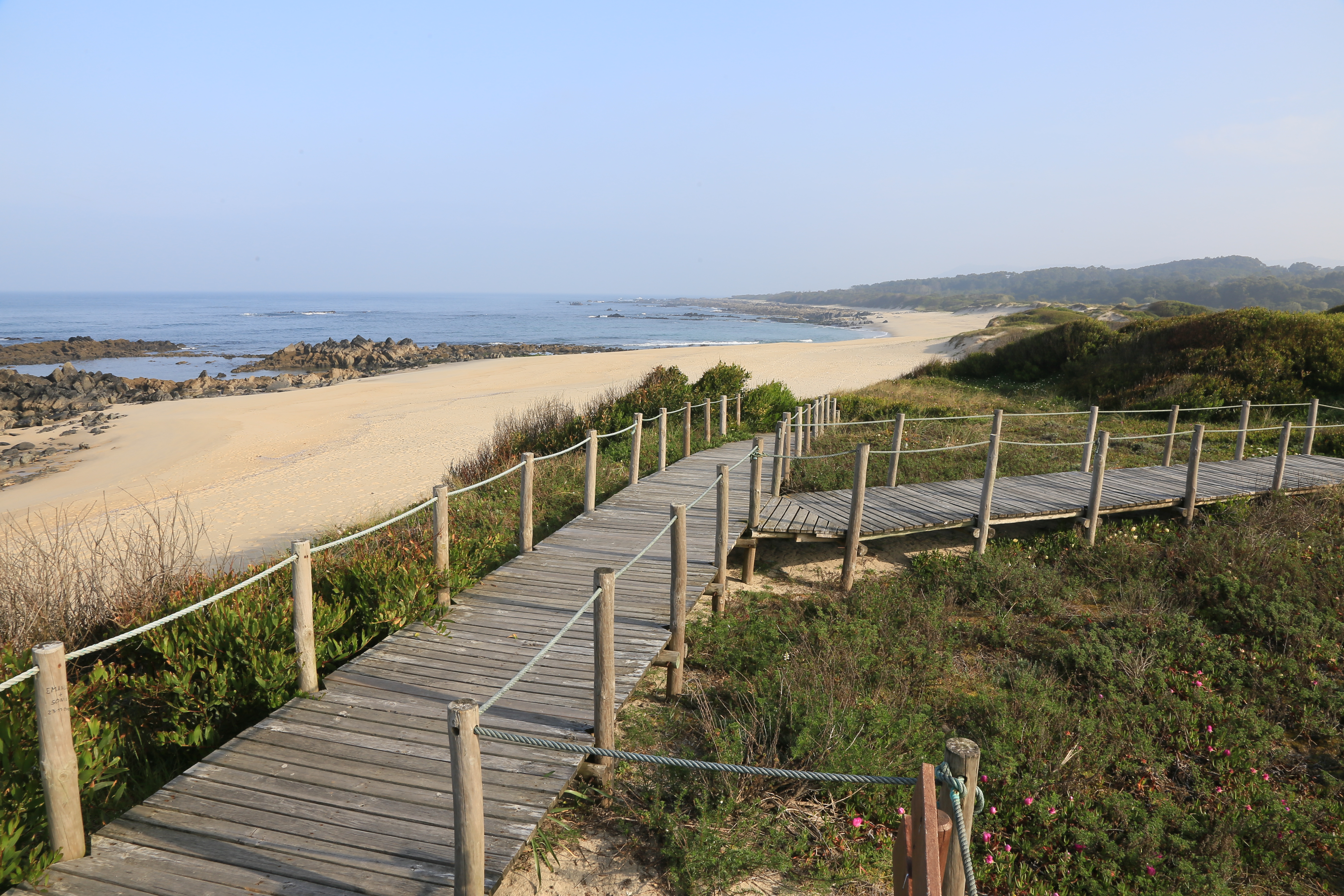 A wooden boardwalk along the sand of Portugal's Costa Verde.