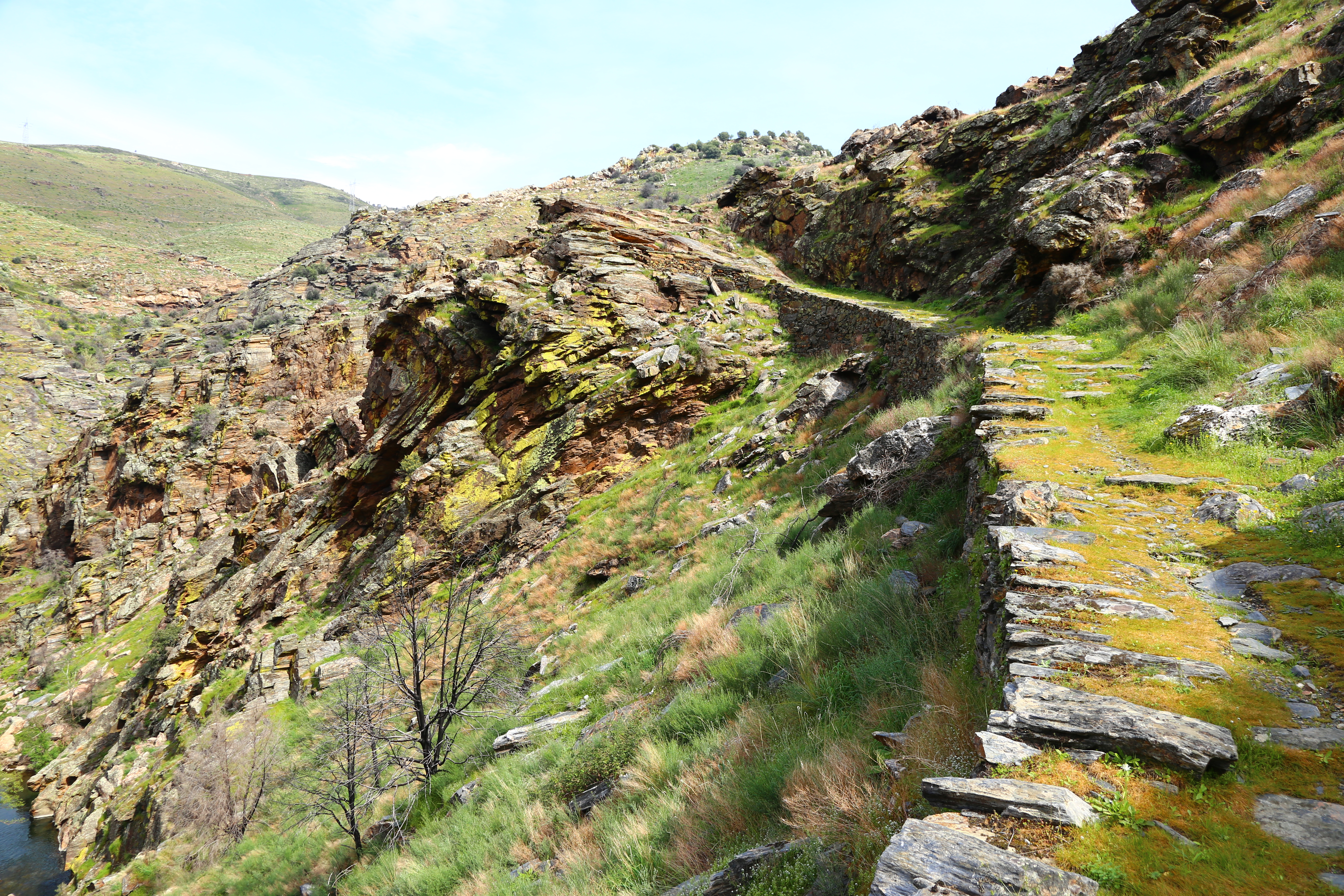 A path over colorful rocks winds through the Coa Valley in Portugal.