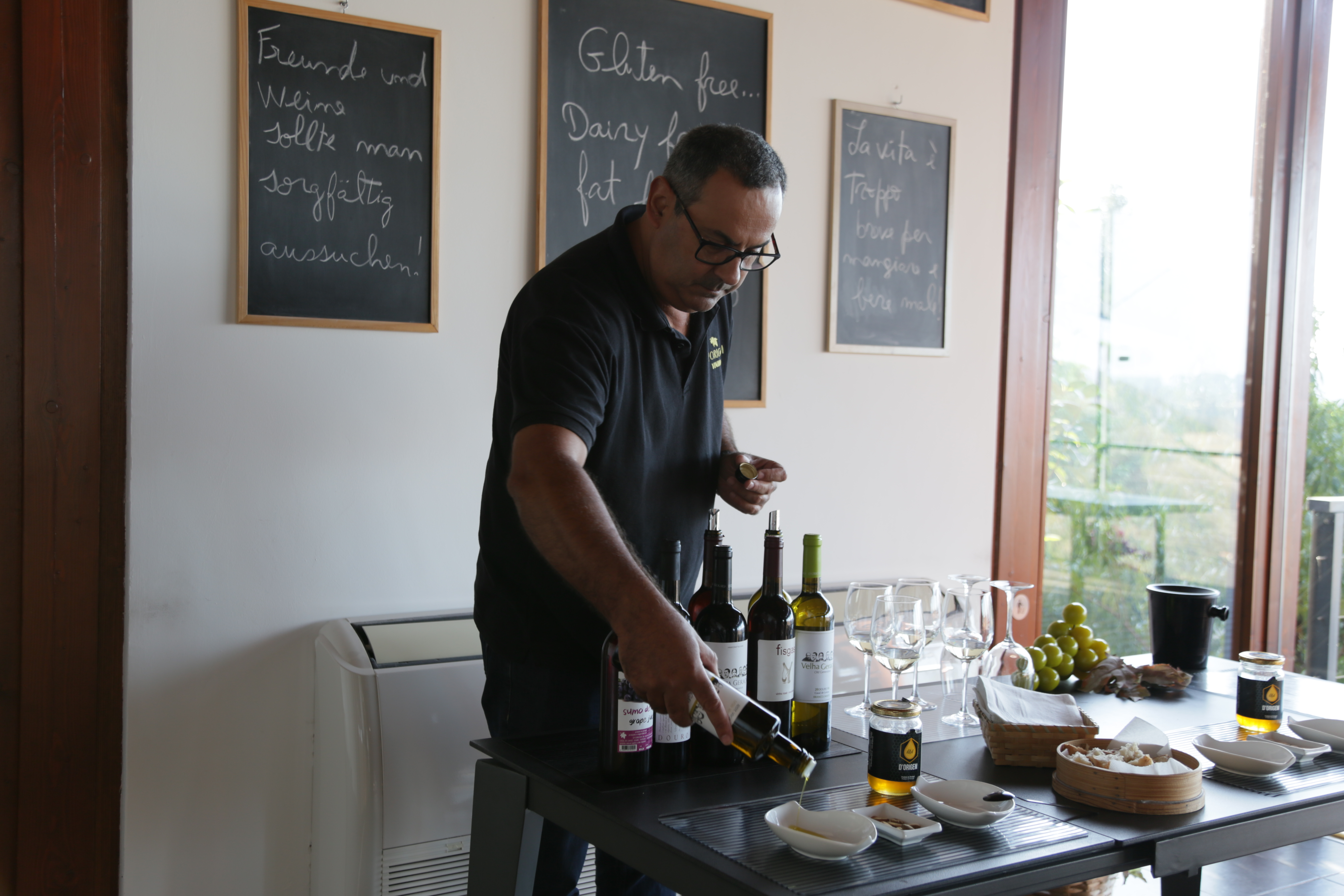 A man pours olive oil during a wine tasting session in Portugal.