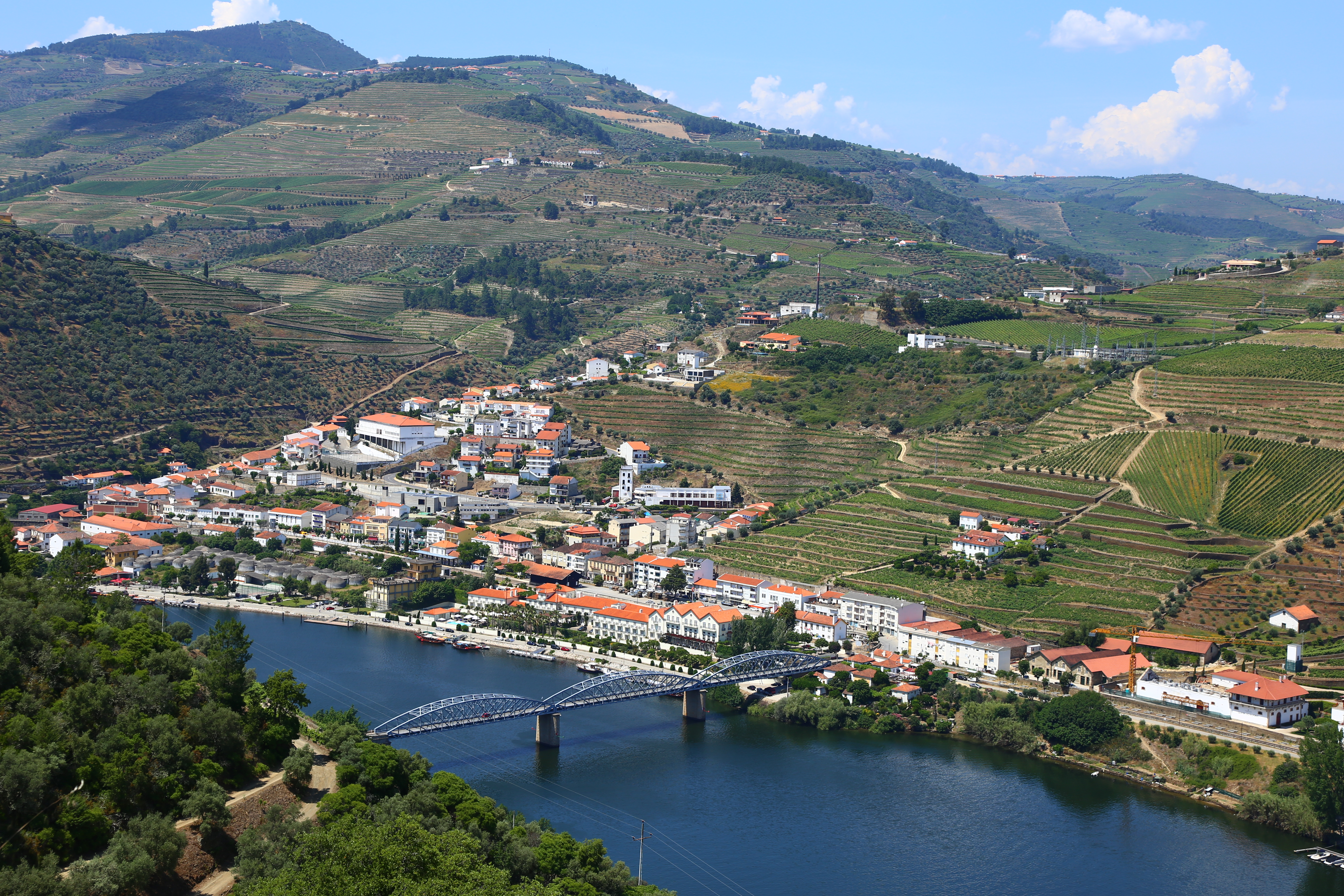 A town in Portugal is shown from above and across a blue river.