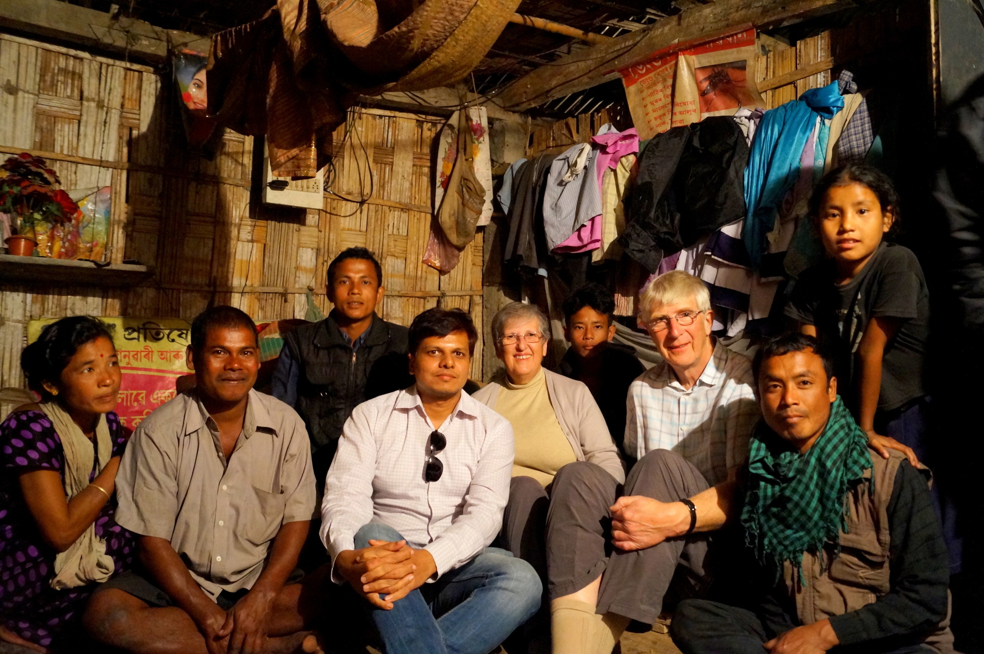 Travelers pose with an Indian homestay family.