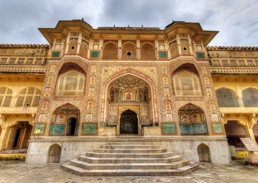 The Amber Palace in Jaipur, India is shown with its elaborate golden facade. This is part of the Golden Triangle Cultural Tour of India.