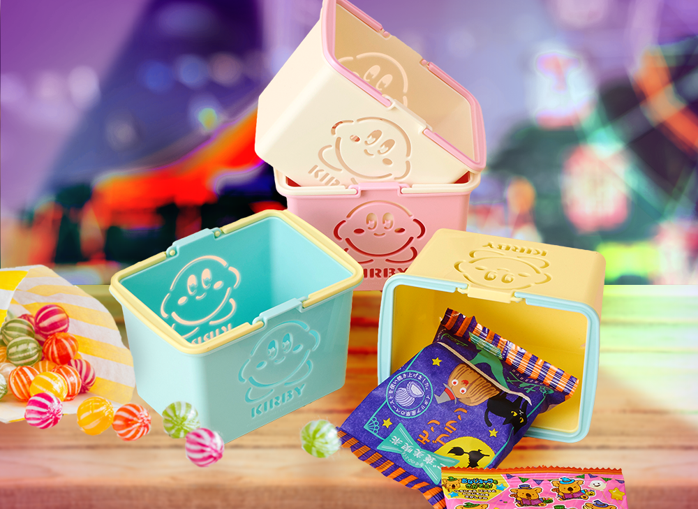 Four mini kirby baskets sitting on a wooden table at a carnival with candy coming out of the baskets