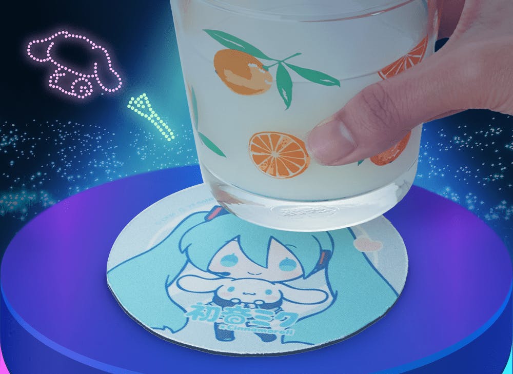 A picture of a hand holding a cup above a Hatsune Miku and Cinnamoroll coaster in front of a dark background with colorful neon lights.