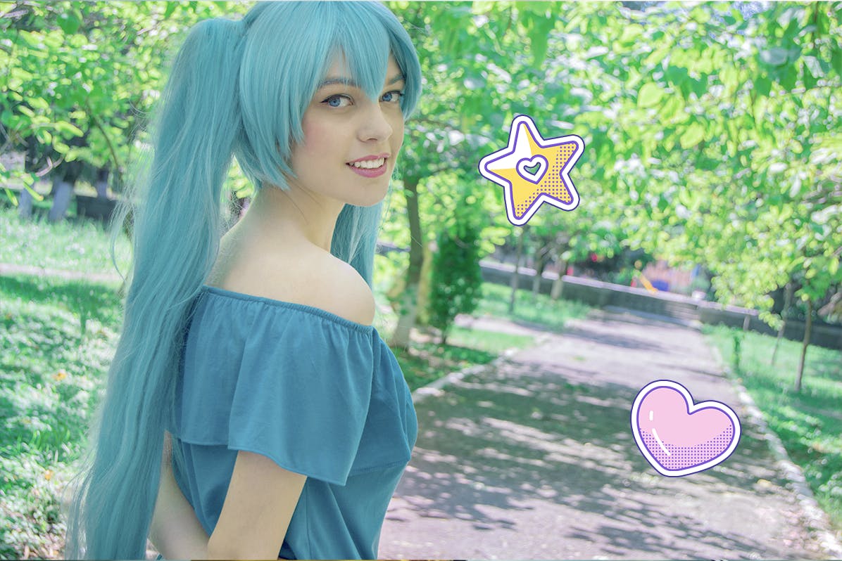 Girl wearing a blue wig like Hatsune Miku walking through a park 