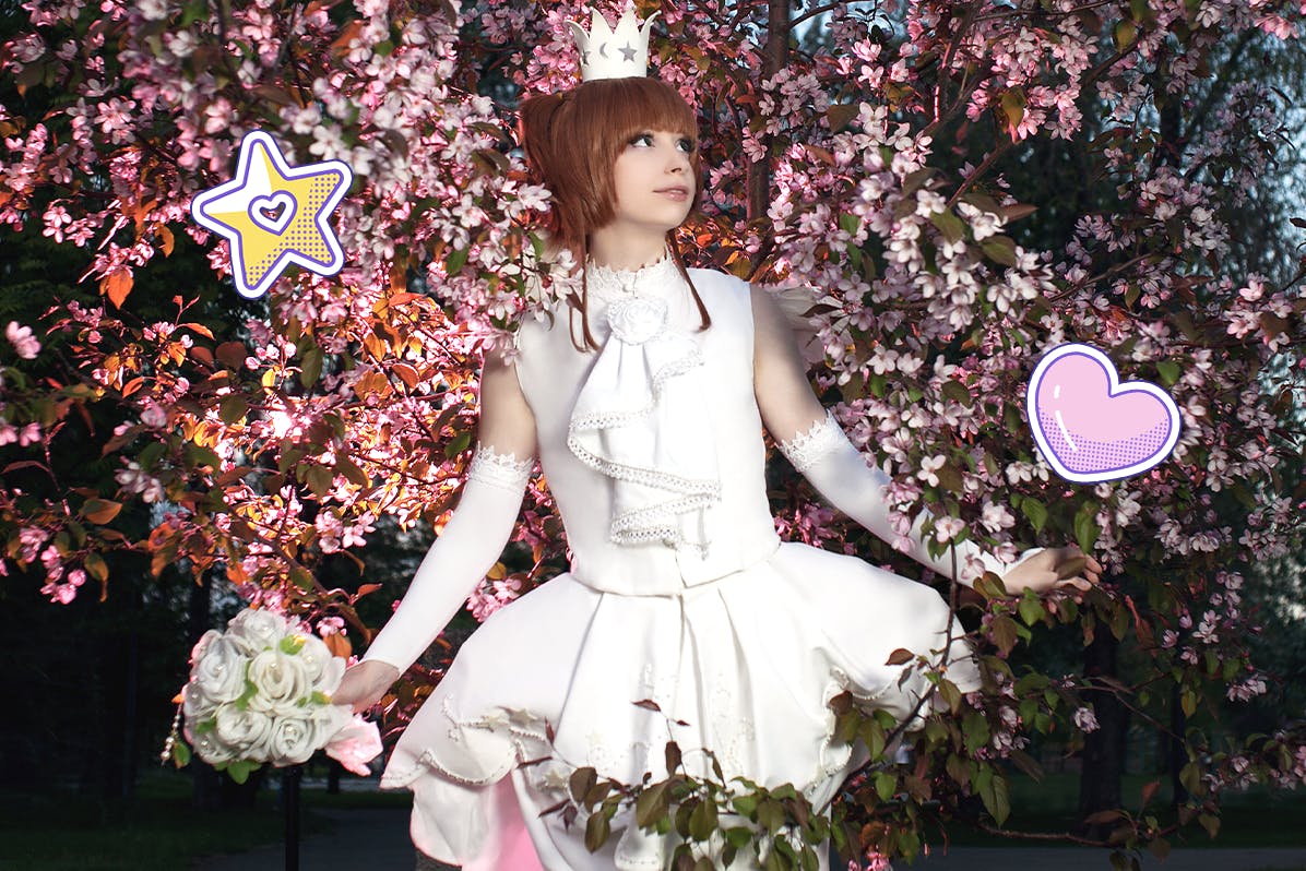 Girl wearing a Cardcaptor Sakura cosplay standing in cherry blossoms