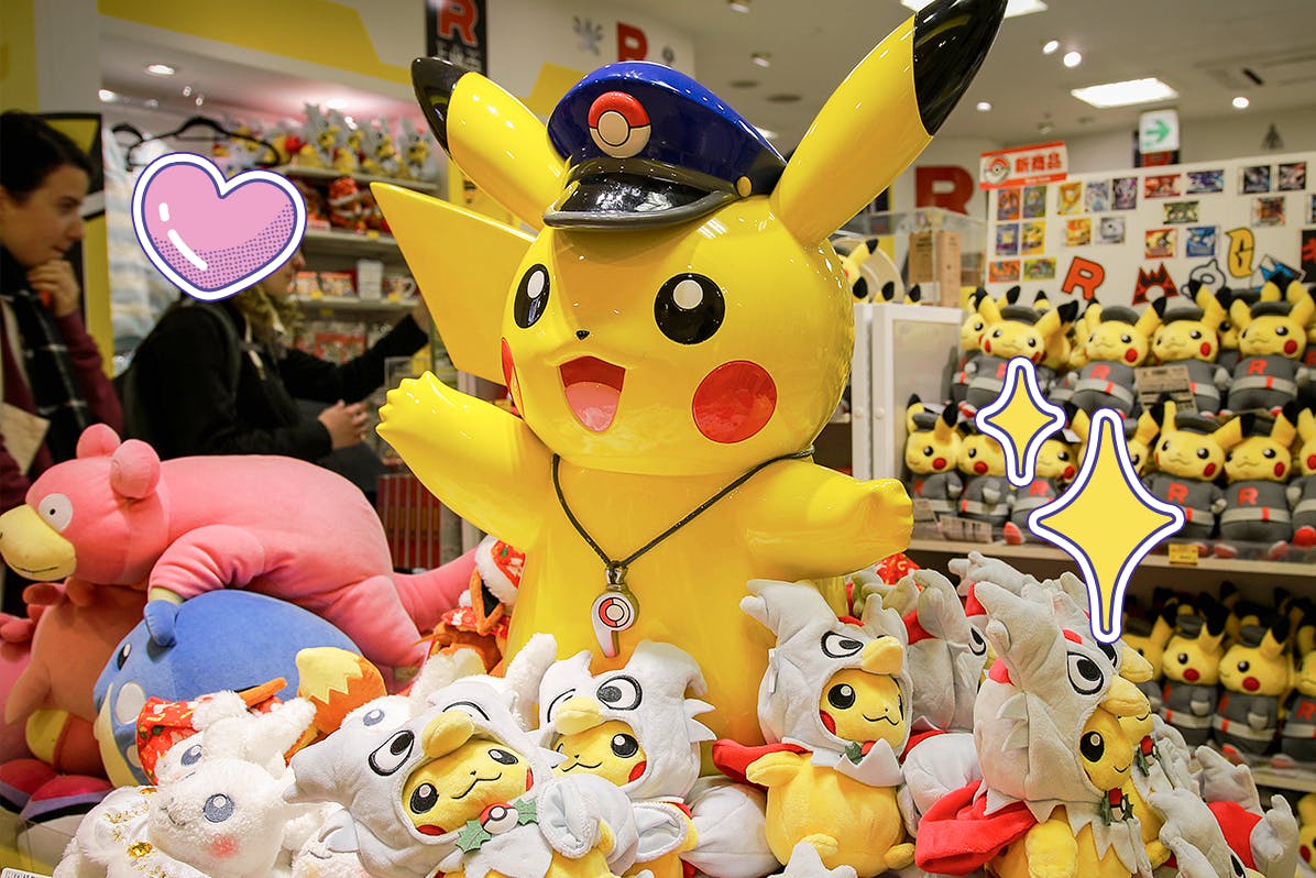 Giant Pikachu figure wearing a police officer hat surrounded by other Pokemon plushies in the Pokemon store in Tokyo
