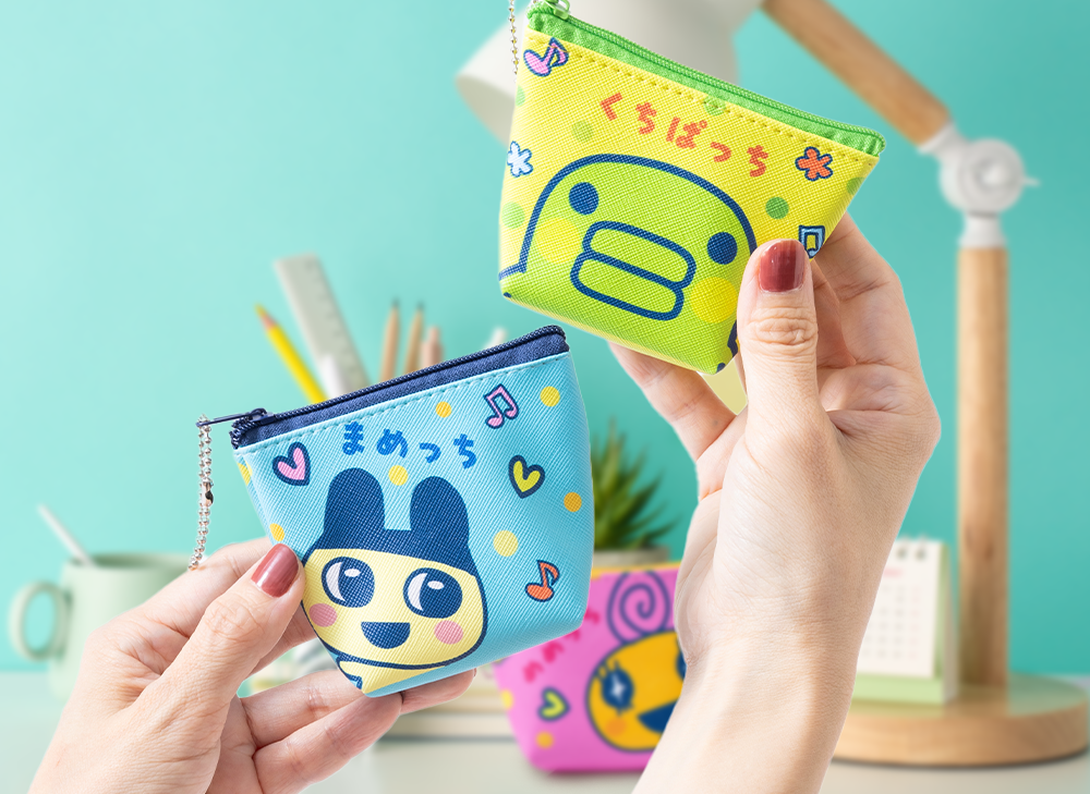 Hand holding up two Tamagotchi mini pouches