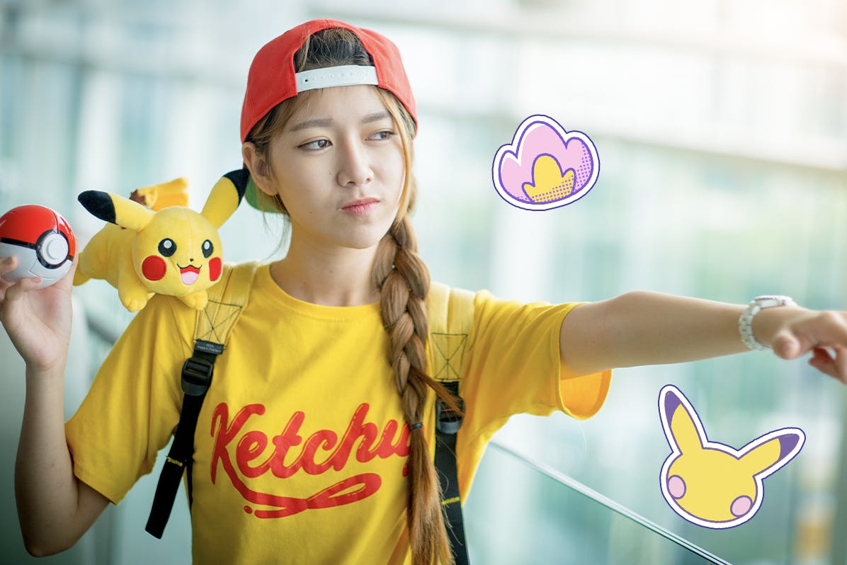 Asian girl holding a Pokeball and a pikachu plushie 