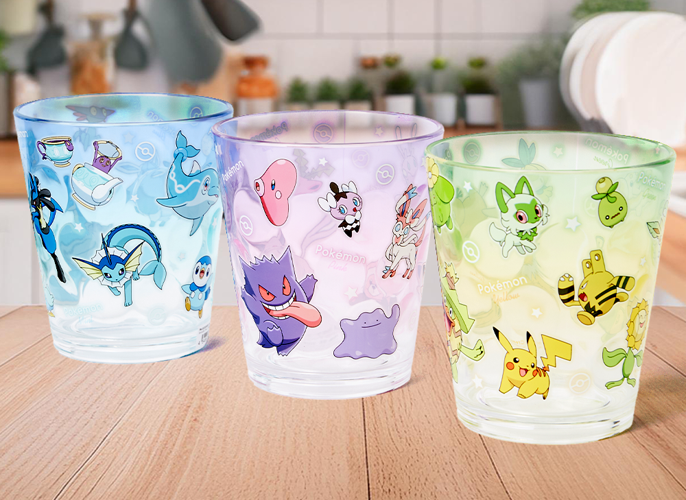 Three pokemon cups sitting on a wooden table 